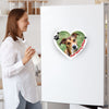 Custom-pet-photo-magnet-heart-shape-chief-security-officer-dog-design. Woman in a kitchen with a heart-shaped magnetic photo of a dog on a refrigerator.